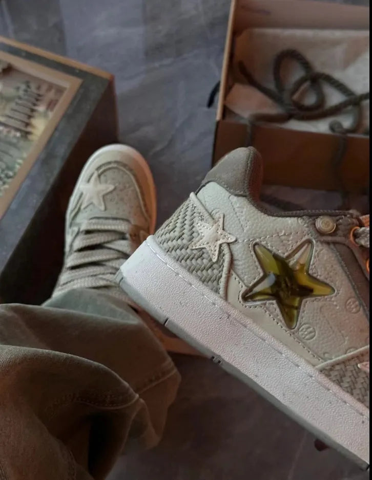 Green low-top casual sneakers with star pattern design on multi-material upper and rubber sole