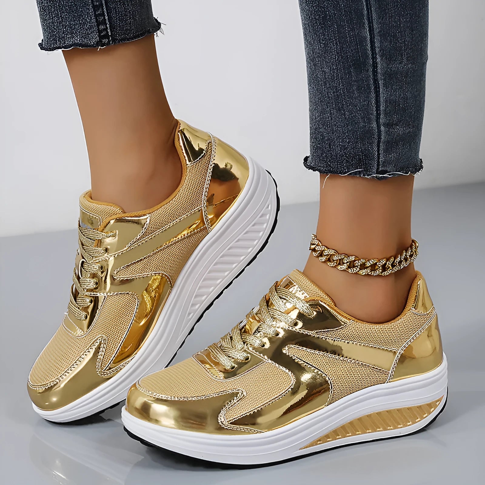 Women's gold platform trainers with mesh upper, cross-strap design and waterproof platform