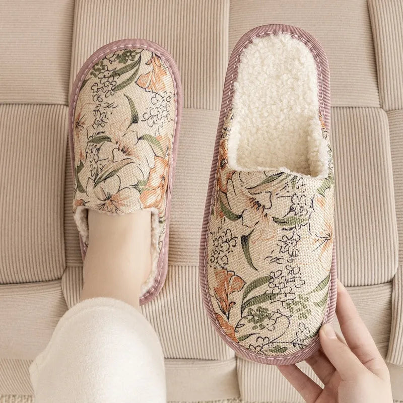 A pair of linen surface cotton lined slippers with a PVC sole, shown in a floral print colour option.