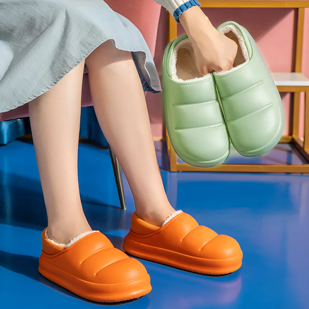 Green EVA waterproof garden slippers with non-slip sole and plush lining shown on wooden decking