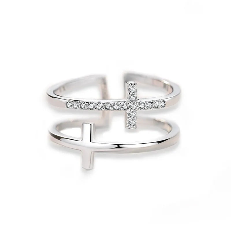 Adjustable double cross geometric ring made of copper with white gold finish and inlaid zircon stones.