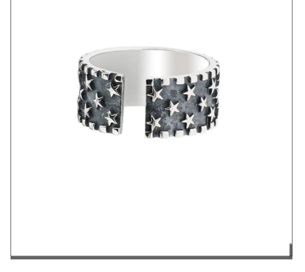 Adjustable sterling silver ring with geometric five-pointed star pattern on band