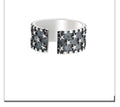 Adjustable sterling silver ring with geometric five-pointed star pattern on band