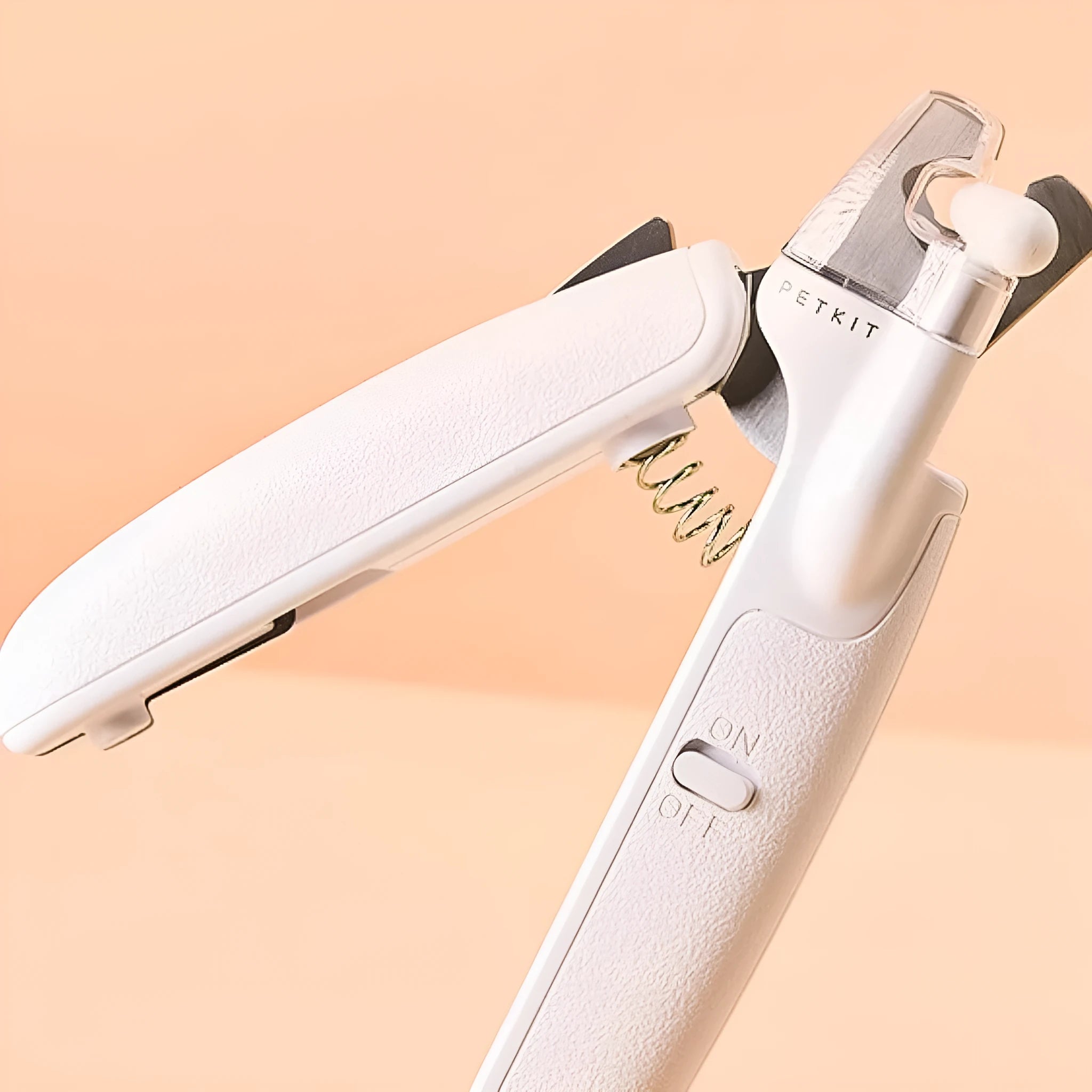 White pet nail clippers with LED light, transparent splash guard, and anti-slip handle.