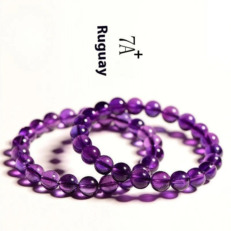 Natural amethyst Uruguay bracelet with scattered beads in various sizes on a wrist.