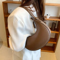 Women's cream yellow retro dumpling-shaped PU leather shoulder bag showing front and internal zippered pocket.