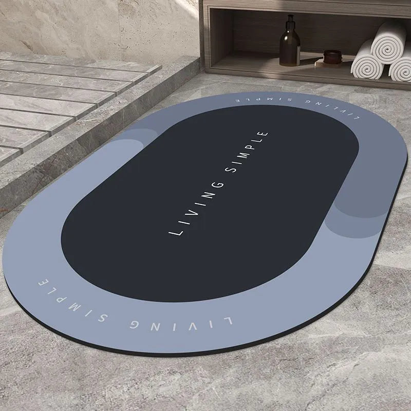 Grey oval super absorbent polyester bath mat with non-slip rubber bottom on tiled floor