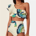 White women's one-shoulder swimsuit showing double-layer lotus leaf detail and a high side leg split.