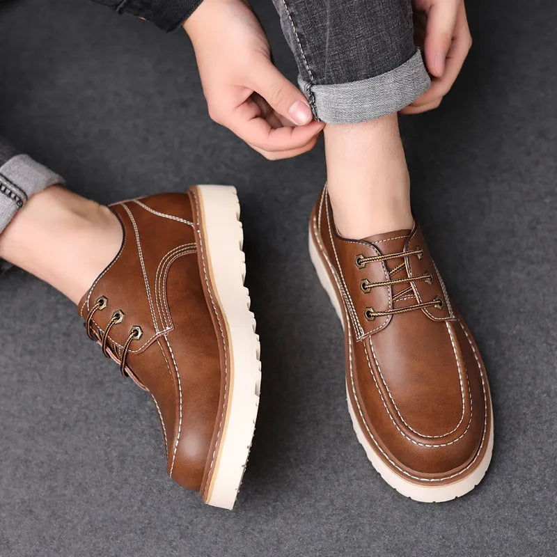 Men's black low-top Martin boots with round toe and rubber sole on a white background.