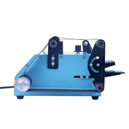 Blue desktop dual-axis belt sander with abrasive belt, shown on a workshop bench.