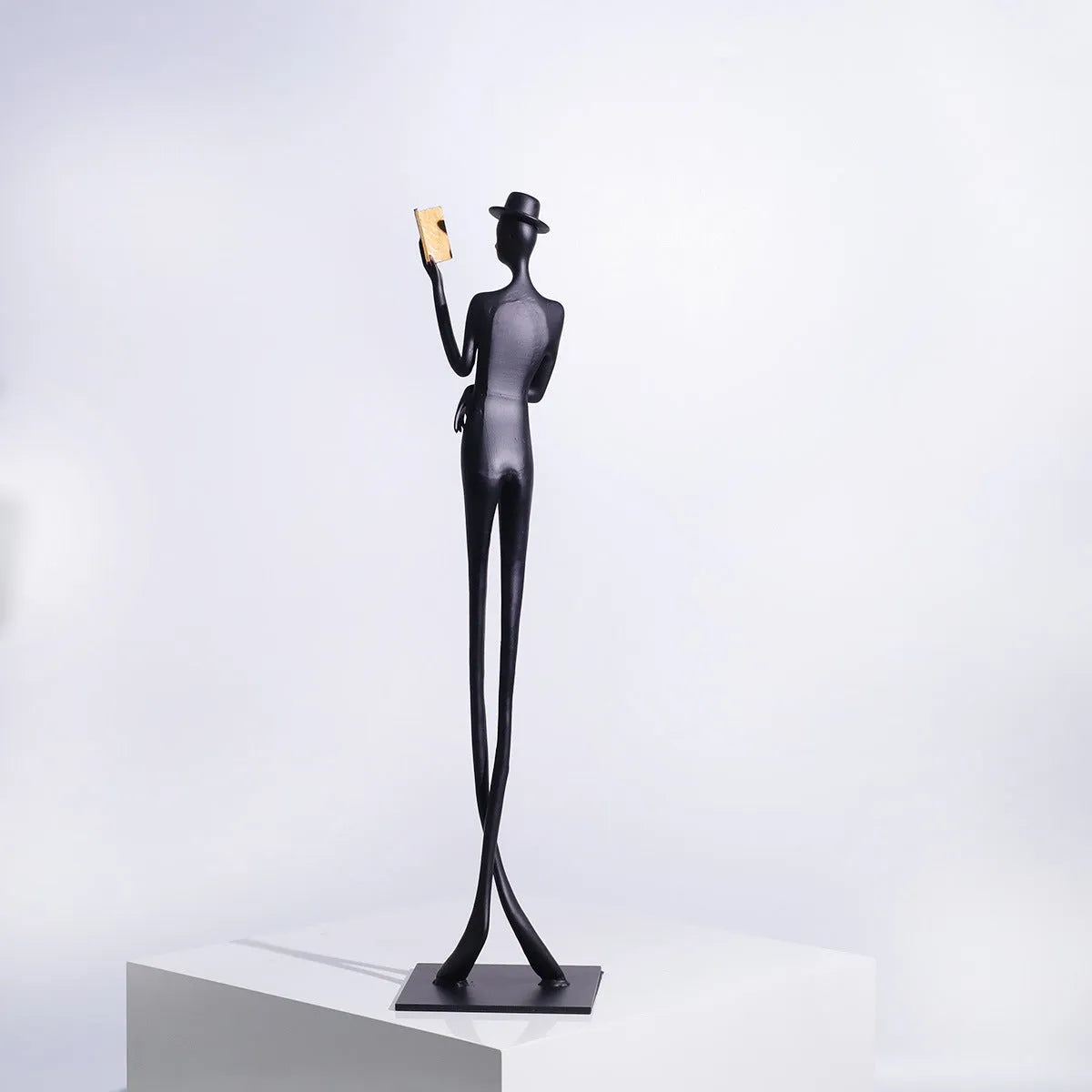 Tall black cast aluminium minimalist character sculpture on a desk, measuring 51cm in height.