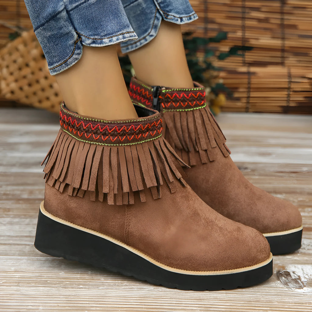 Women's dark brown suede wedge ankle boots with a side zipper and decorative tassel.