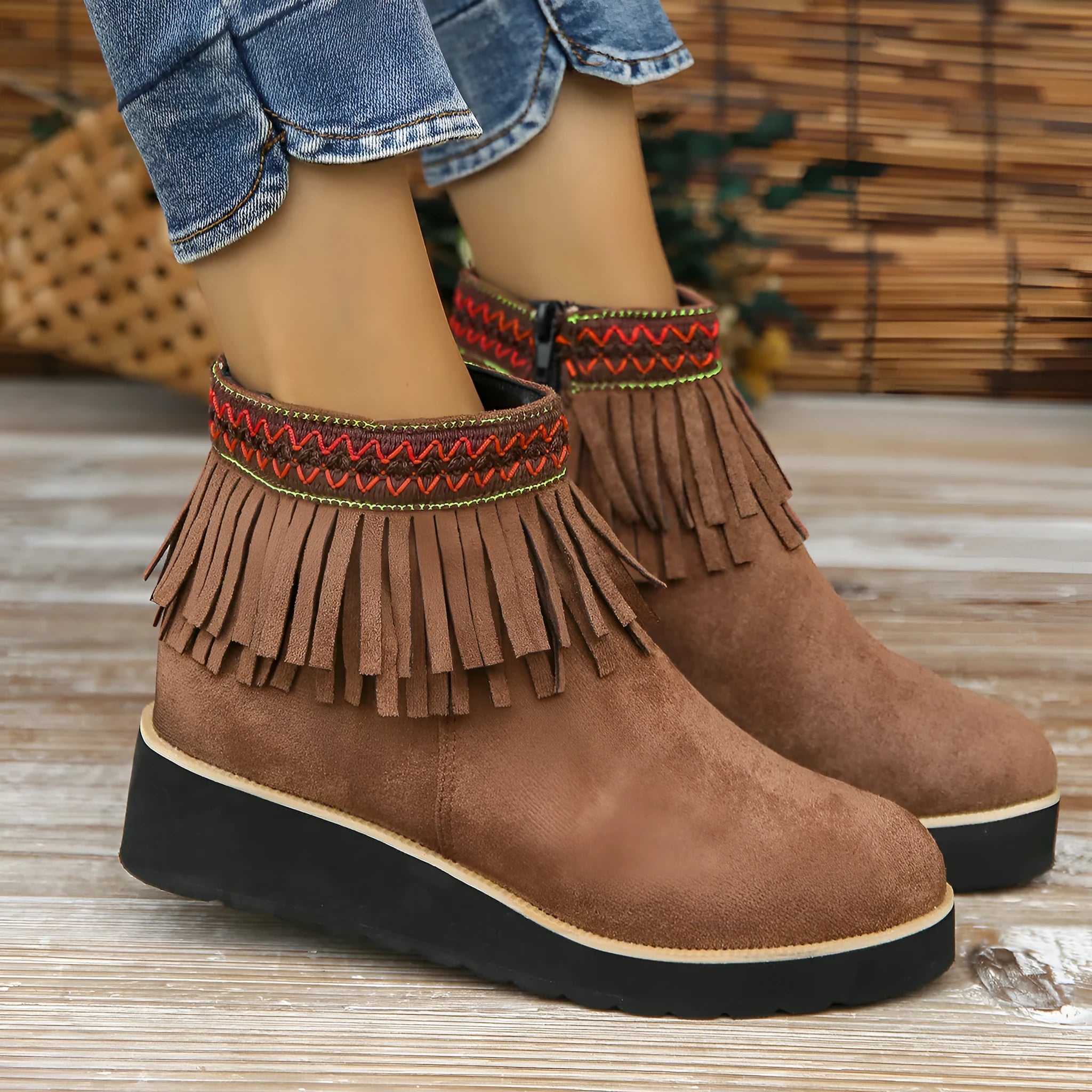 Women's dark brown suede wedge ankle boots with a side zipper and decorative tassel.