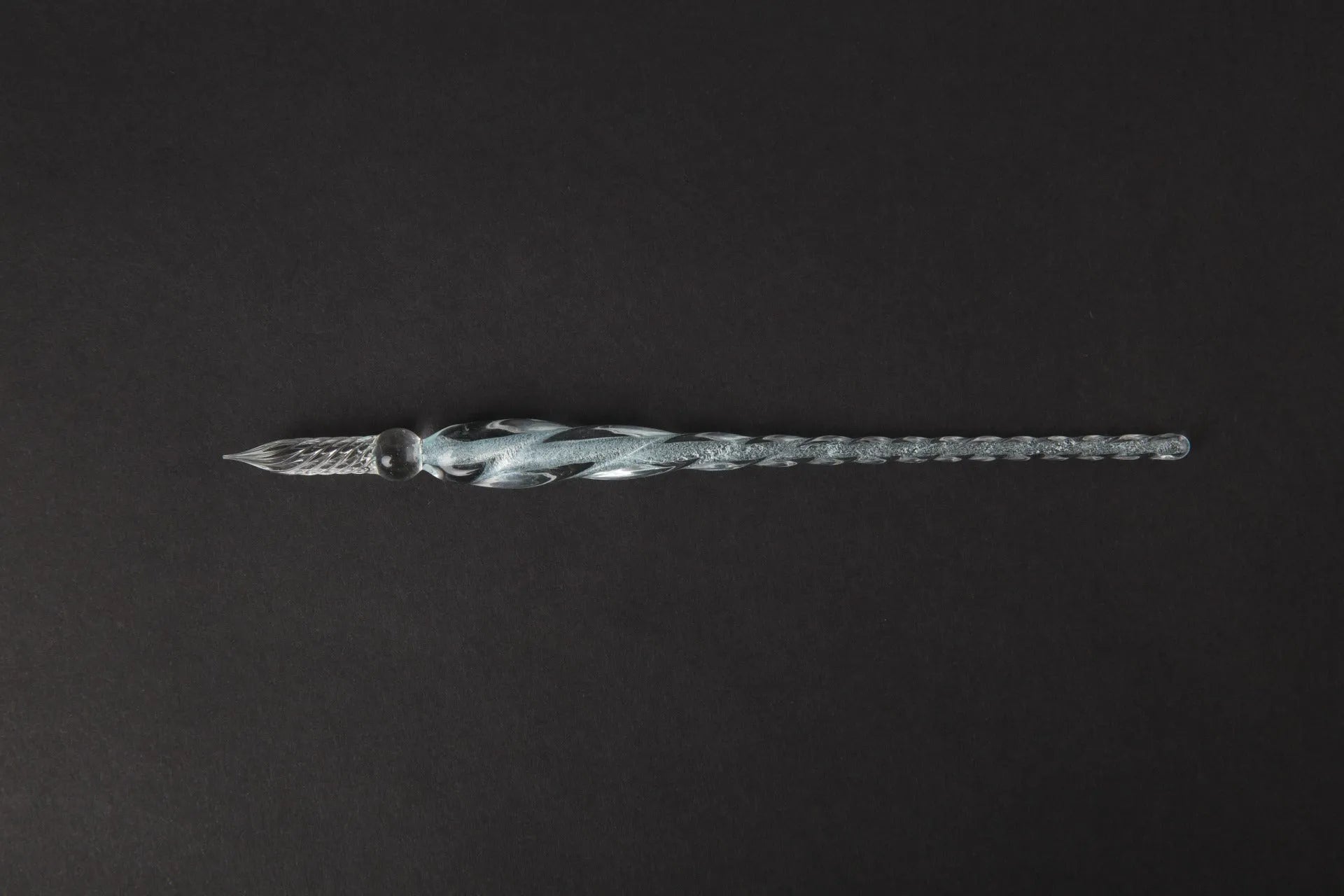 Transparent glass art pen with coloured ink dipped design in a gift box.
