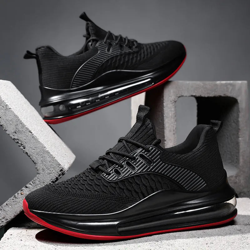 Men's black low-top running shoes with mesh upper and white rubber sole on a plain background.