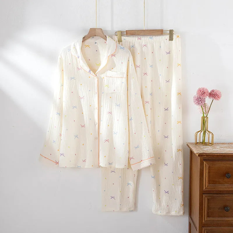 Beige and pink women's long-sleeved cotton pajama set with trousers on a hanger.