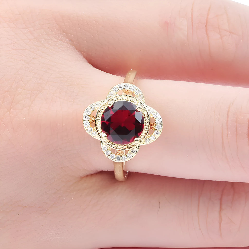 Copper ring with fruit shape and inlaid zircon details on a finger.