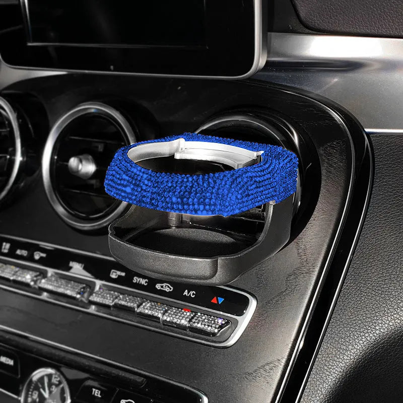 White diamond-encrusted ABS plastic car cup holder bracket mounted on a car air vent.