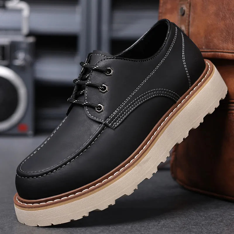 Men's black low-top Martin boots with round toe and rubber sole on a white background.