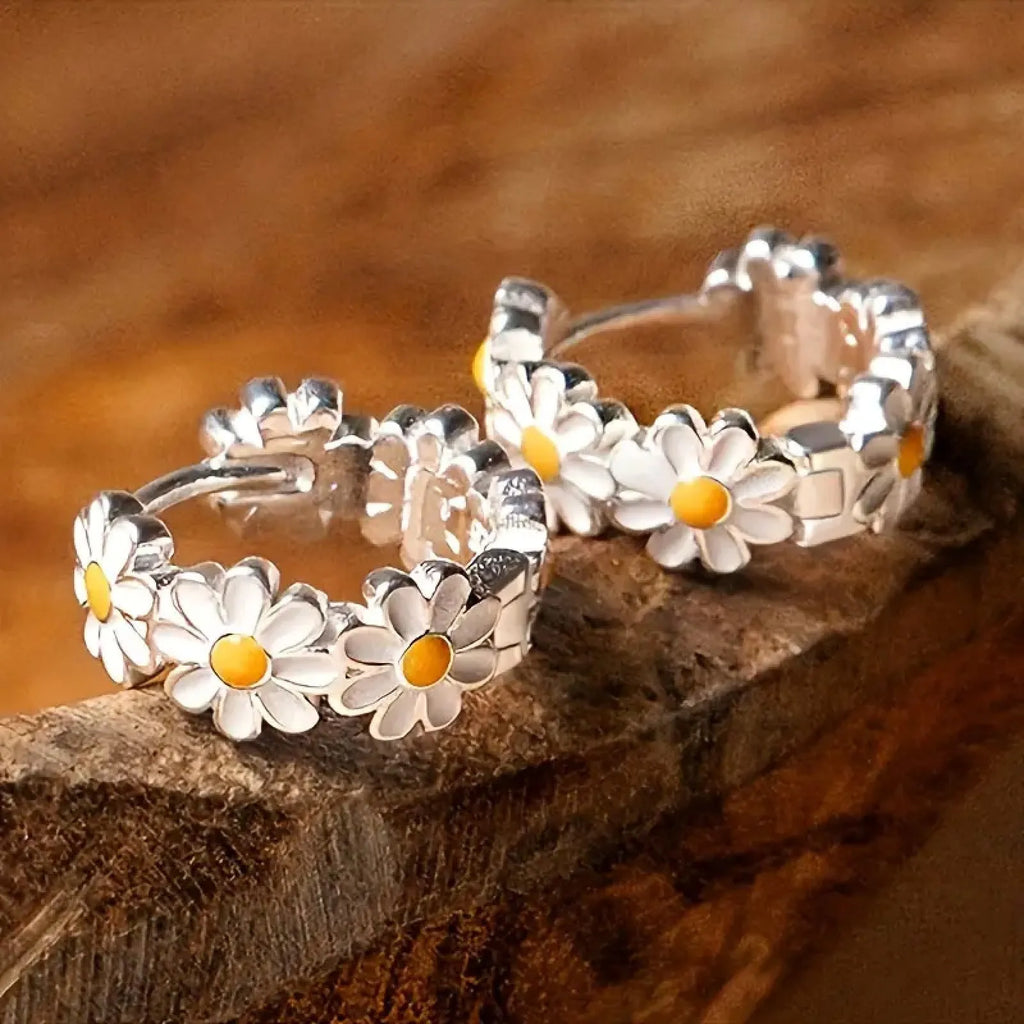 White platinum-electroplated daisy flower ring earrings with gemstone details on a copper base.