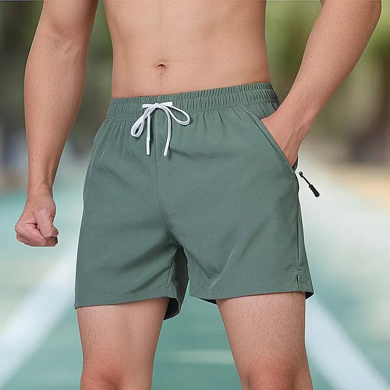 Men's black high-waist polyester training shorts with drawstring waist on a mannequin.