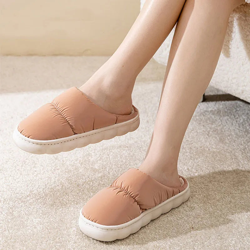 Pair of thick-soled winter slippers with artificial leather upper and plush lining, shown in a choice of colours.