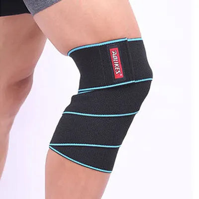 Aolikes orange lifting knee wrap with velcro, stretched to show 5.25 feet length for squat support