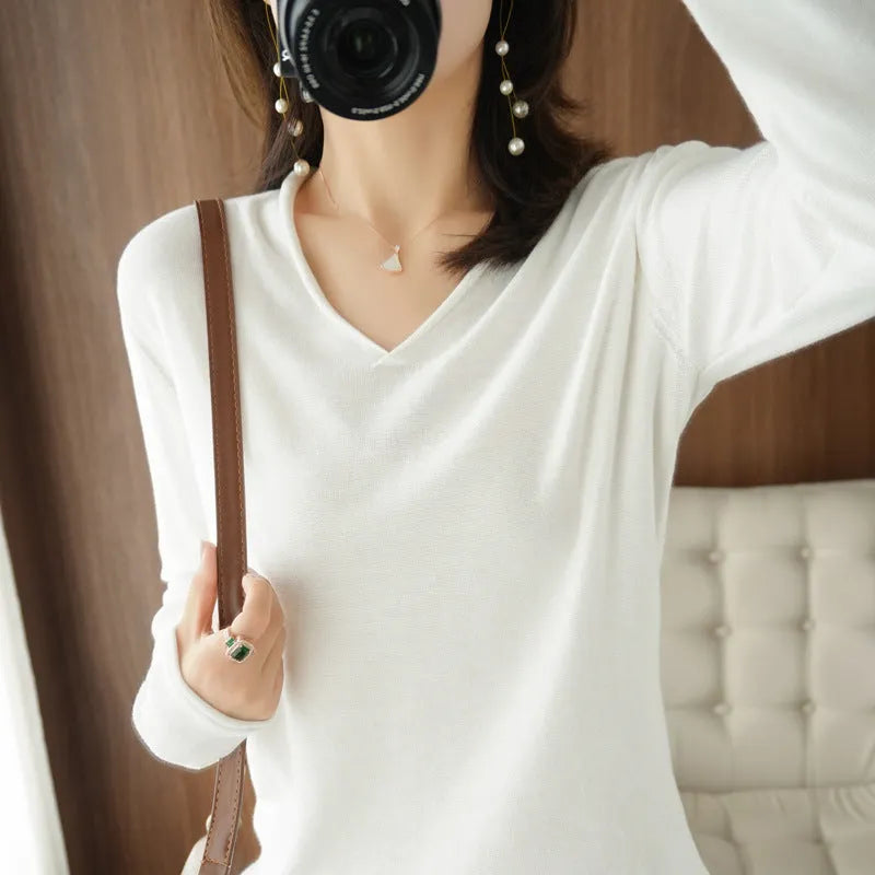 Women's V-neck long sleeve knitwear pullover top in a macaron colour on a hanger.