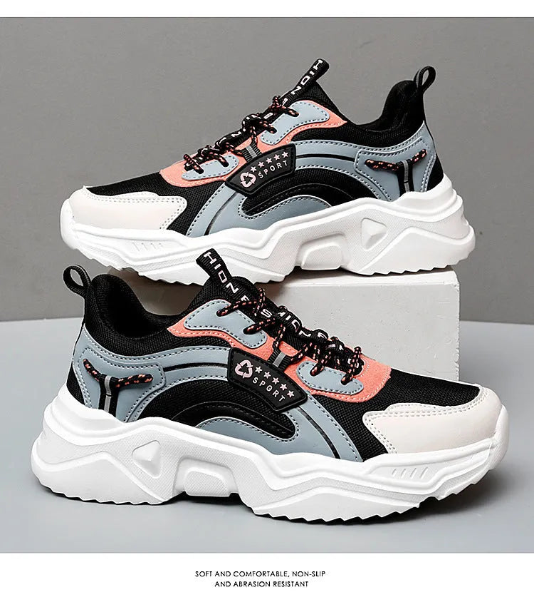 Women's white thick-soled casual sneakers with mesh upper and buckle detail on a light background.
