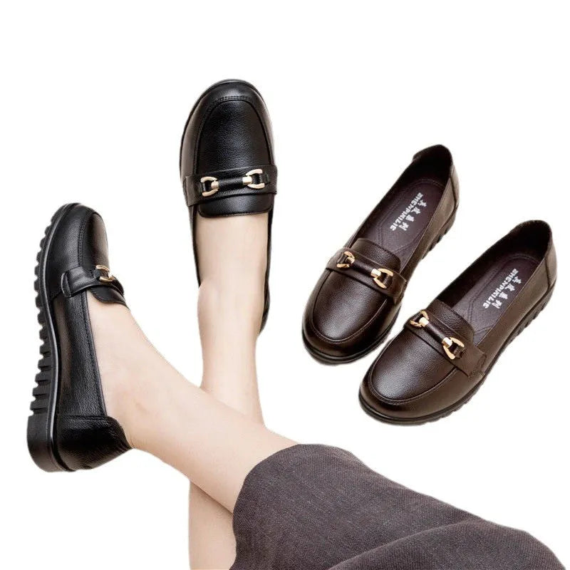 Black leather pumps with soft rubber soles, microfibre upper, and low flat heels on a white background