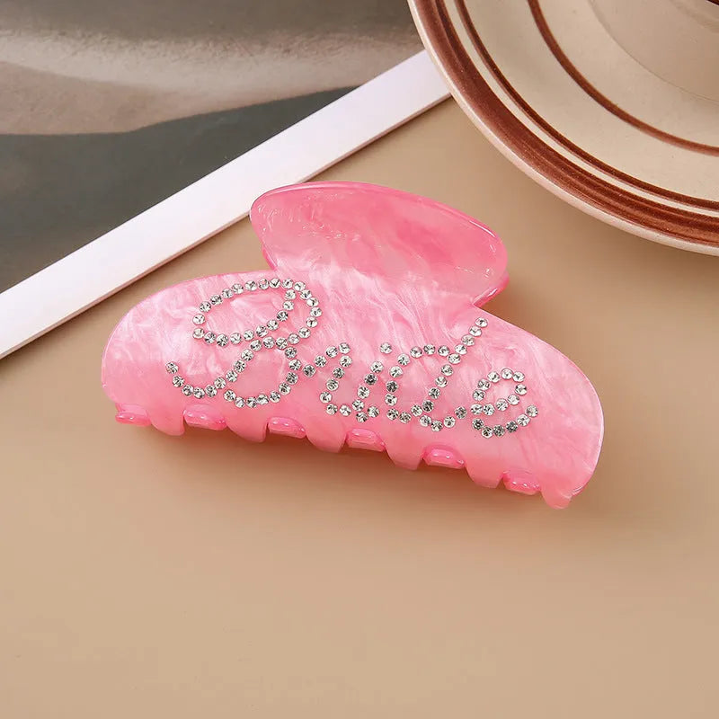 Acrylic hair barrette with sparkling diamond spot drills and English letters in pink or white.
