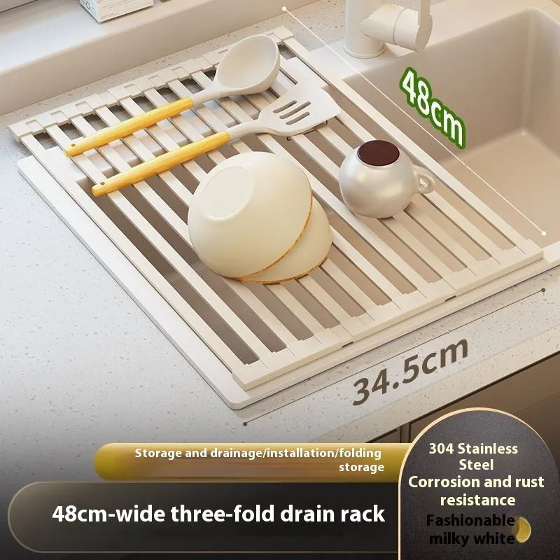 A milky white foldable stainless steel kitchen draining rack shown open on a countertop next to a sink.