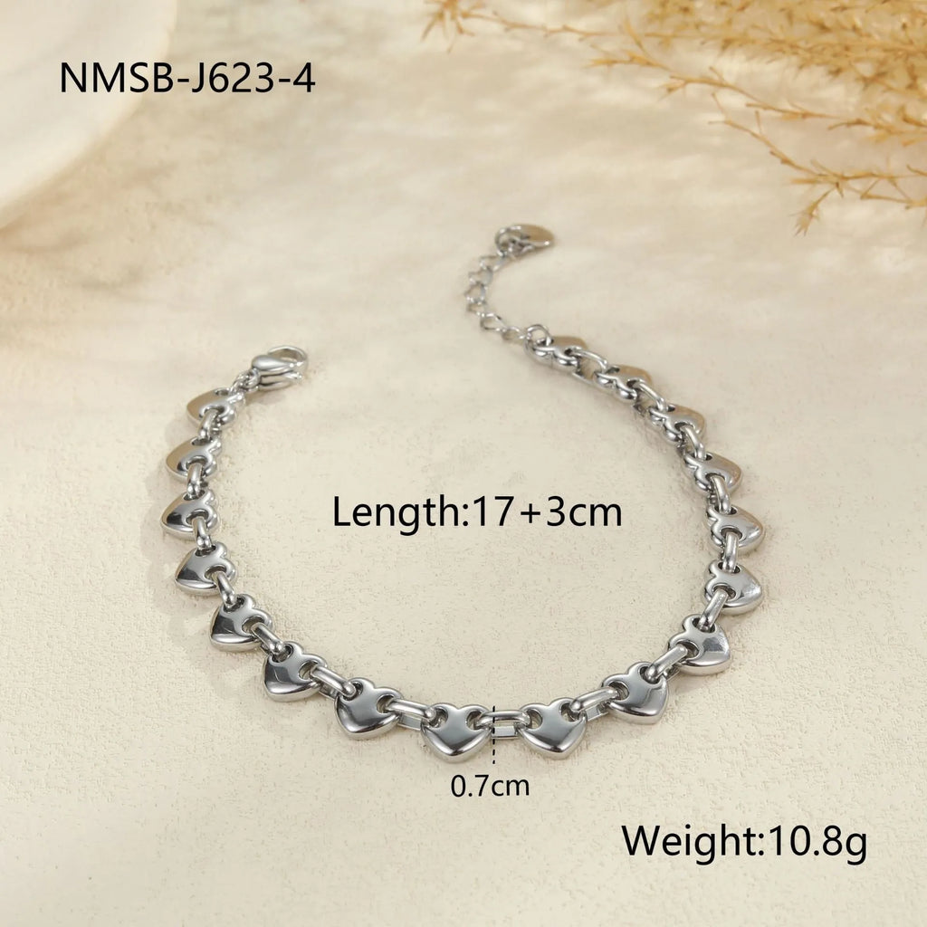 Stainless steel bracelet with a hollowed-out heart charm in a gold electroplated finish.