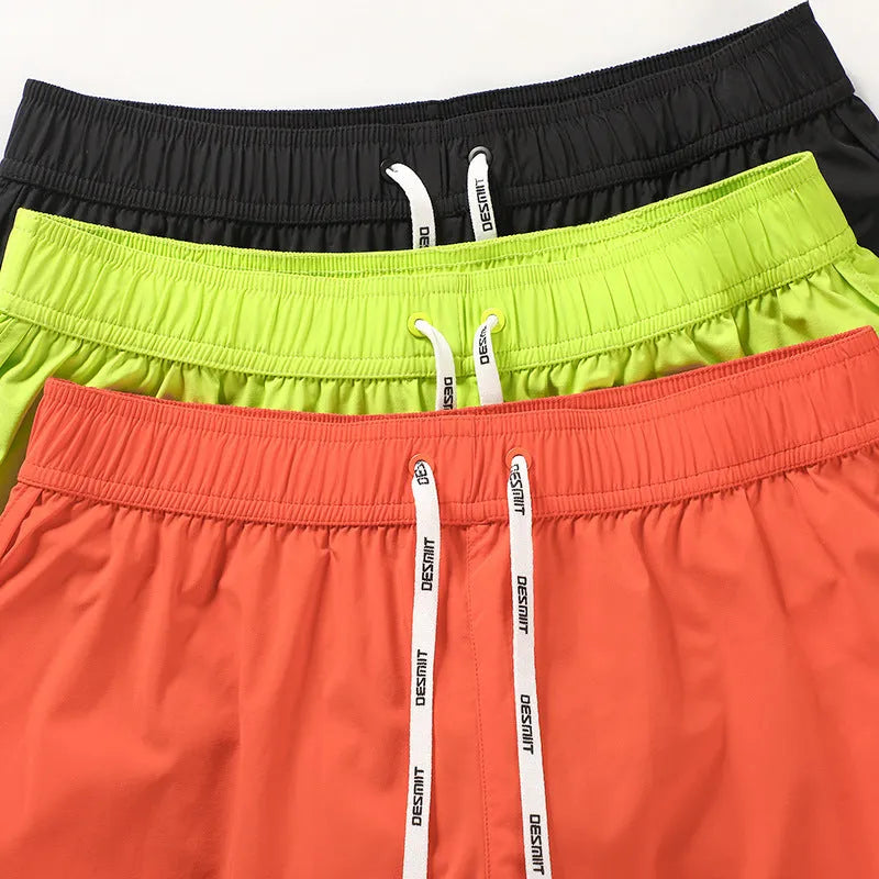 Men's loose fitting beach surfing trousers in polyester available in fluorescent green, orange red and black colours