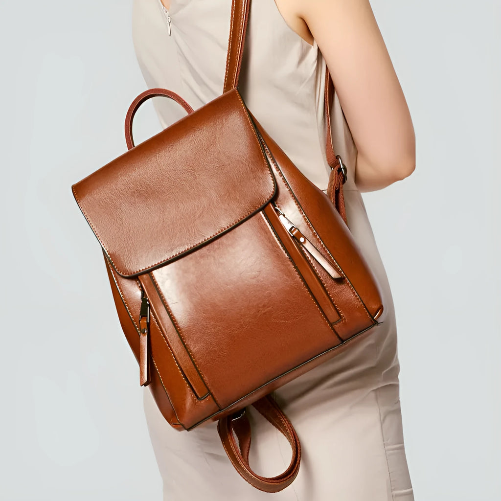 Large genuine leather women's backpack in black with stitching detail and dual straps.
