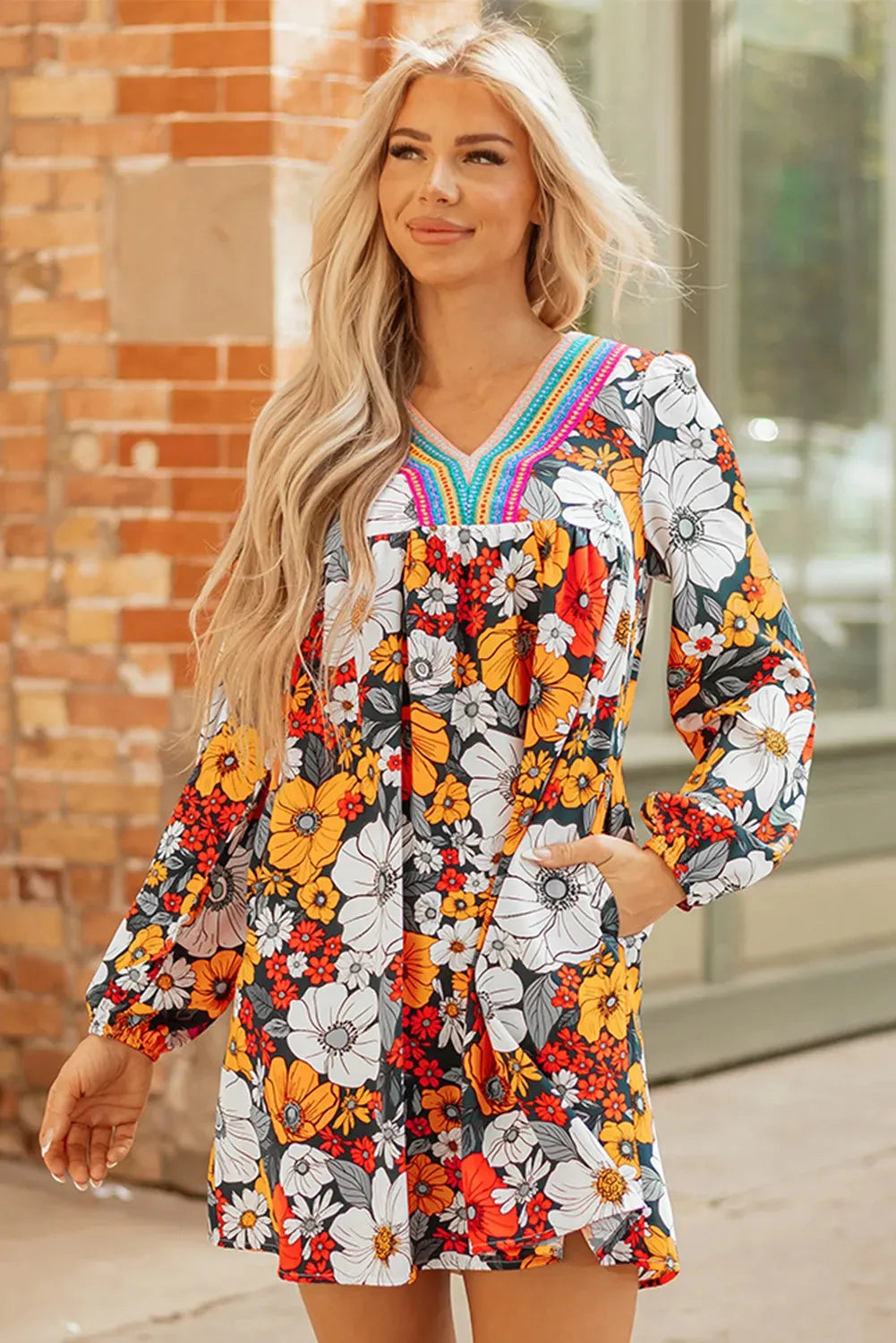 Orange floral print women's mini dress with lace-trimmed V-neck and long sleeves.