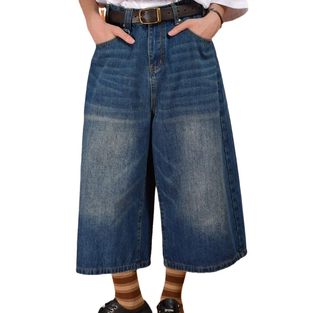 Men's loose straight-cut denim shorts in blue, shown on a hanger.