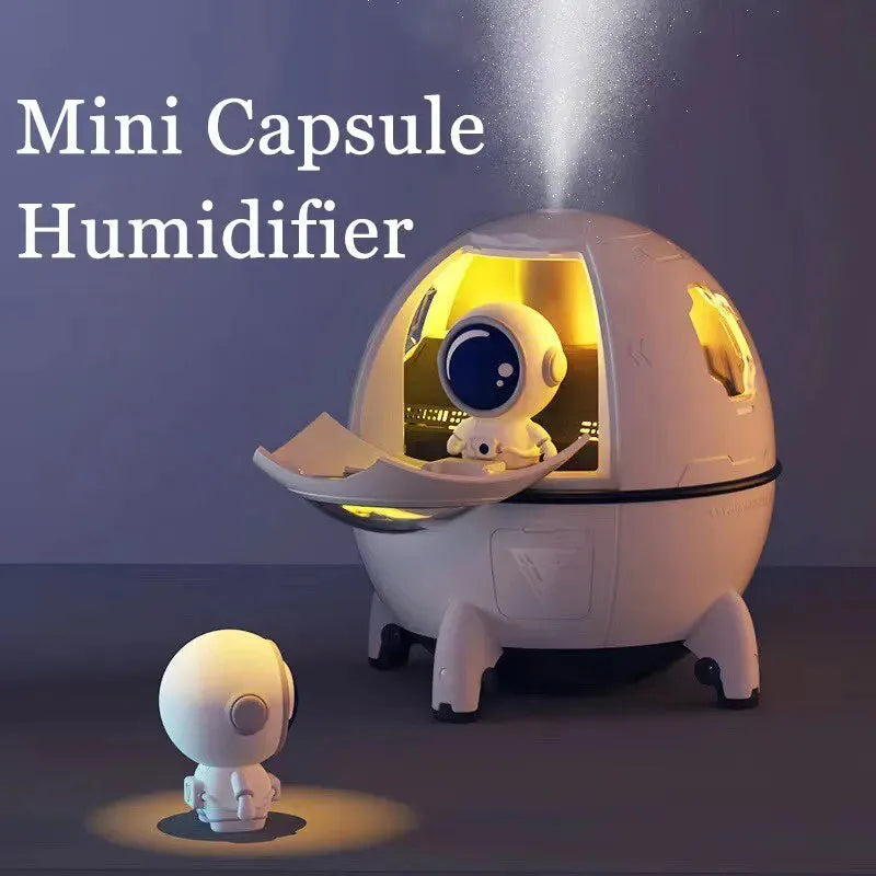 Light purple astronaut capsule-shaped portable USB humidifier on a desk