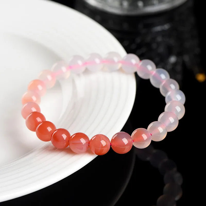 Natural gradient Yanyuan agate bracelet with geometric beads in salt source colour on a white background
