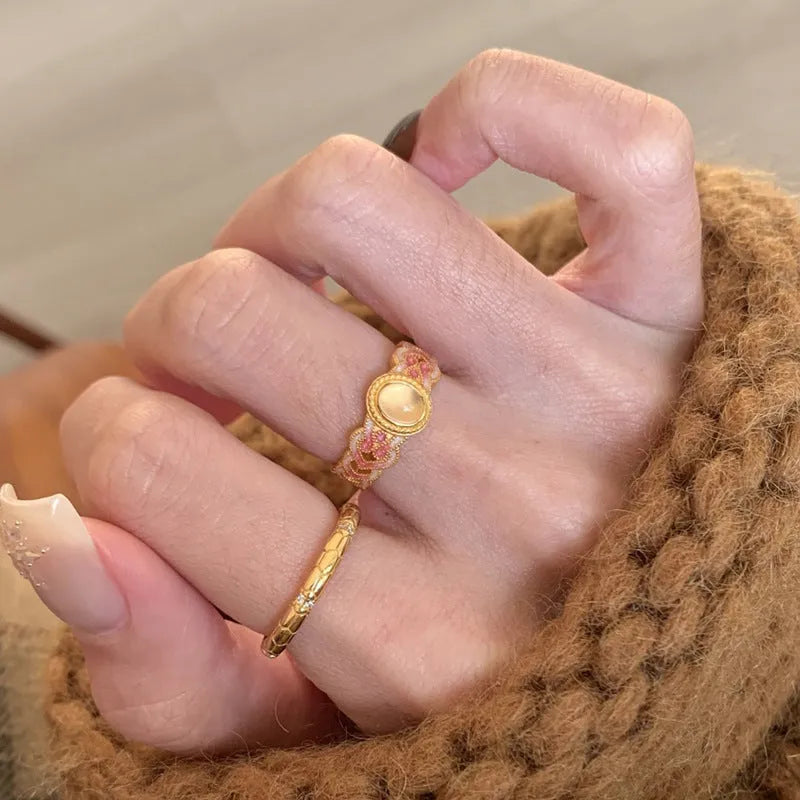 Geometric open ring for women with pink crystal enamel detail on a gold-plated copper band.