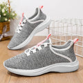Women's low-top Flyknit mesh sneaker in black with round toe and lace-up front.