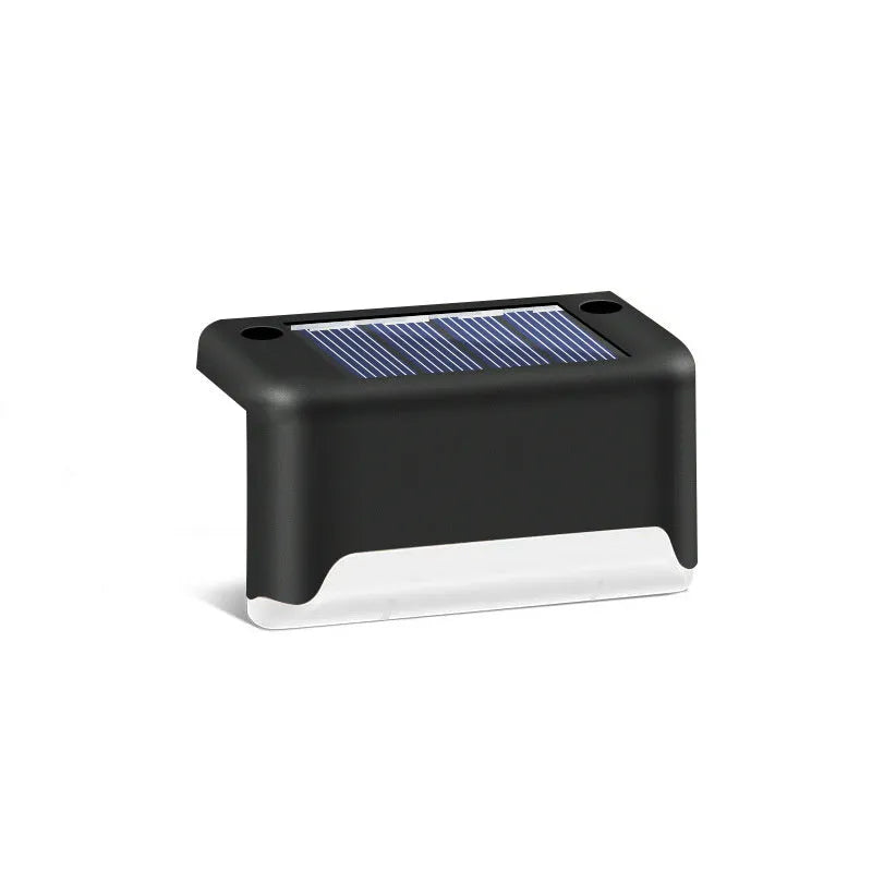 black solar courtyard stair light with ABS body on a garden step