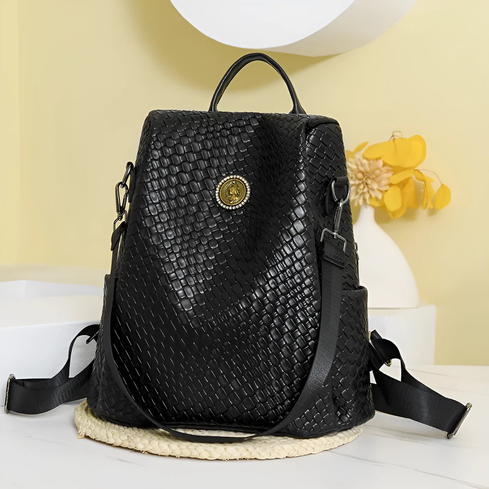 Women's black anti-theft backpack with weaving stitching detail and multiple internal compartments