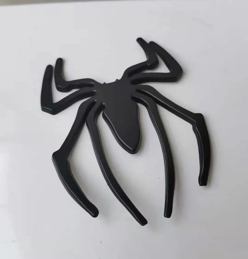 Three-dimensional metal spider bumper sticker in zinc alloy, showing detailed design