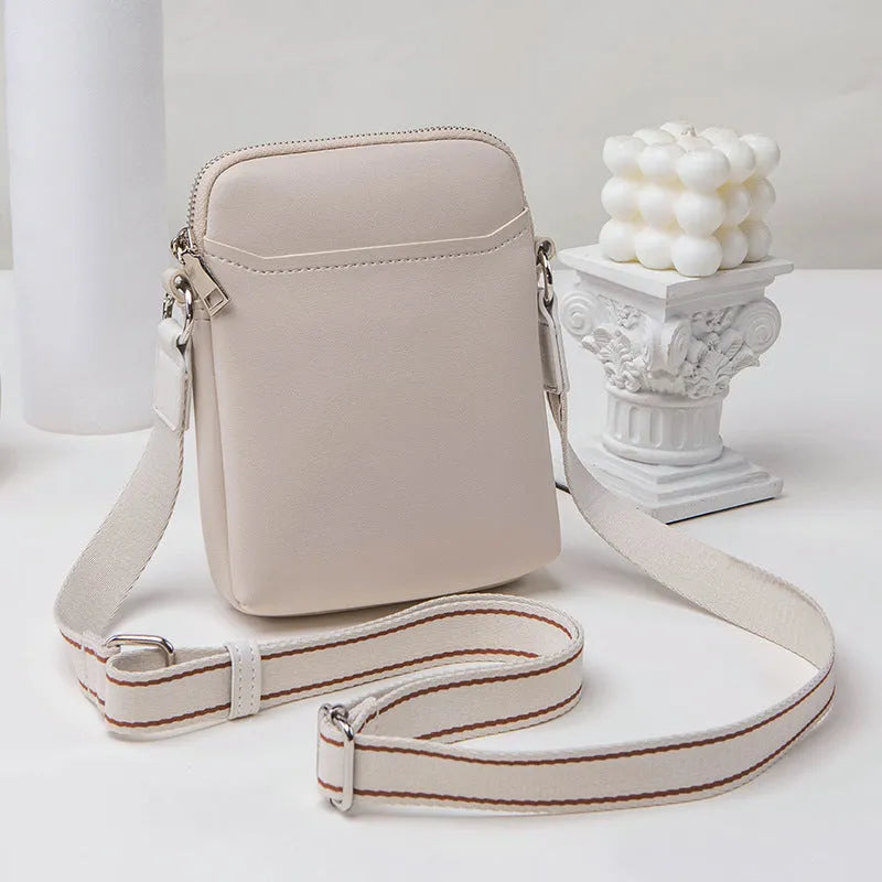 Solid colour small crossbody shoulder bag in PU leather measuring 14.5cm by 5.5cm by 19cm