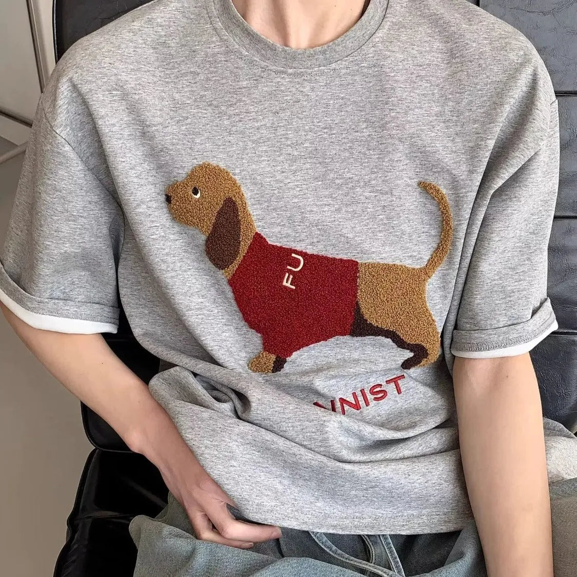 Grey men's T-shirt with a raised towel embroidery sausage dog design on the chest.