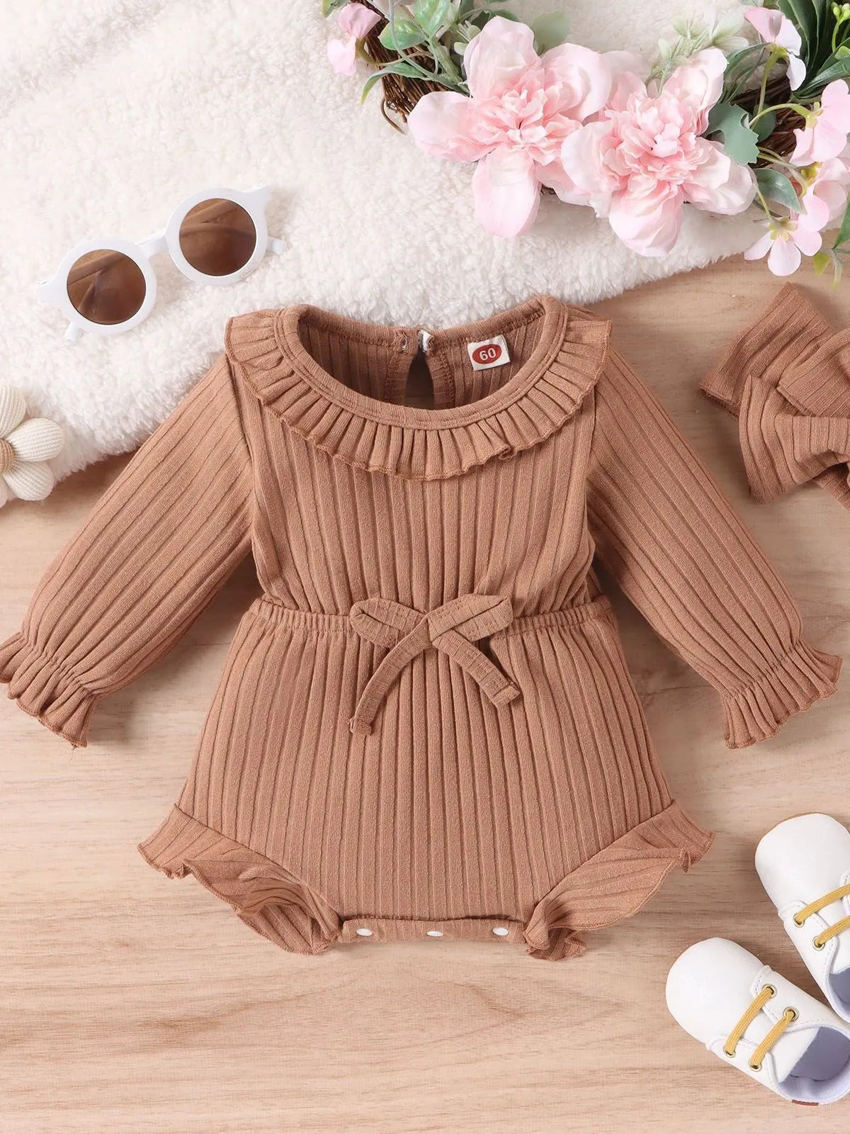 Baby girl wearing long sleeve cotton striped romper and headscarf in white