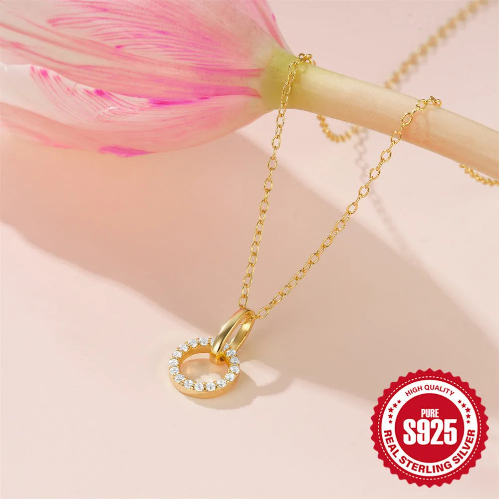 Gold-colour sterling silver necklace with geometric zircon pendant on an adjustable clavicle chain.