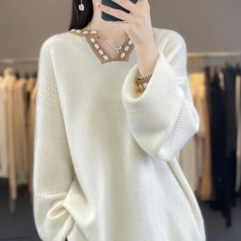 Women's camel coloured V-neck viscose sweater with long sleeves laid flat.