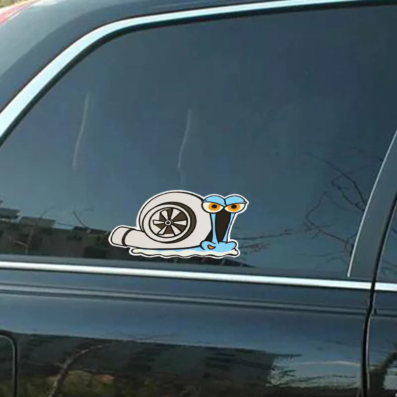 White reflective car sticker with a cartoon snail design, measuring 12 by 8 cm.